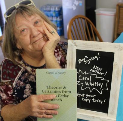 Carol with her newly published book in 2019. Photo by Britne Hammons